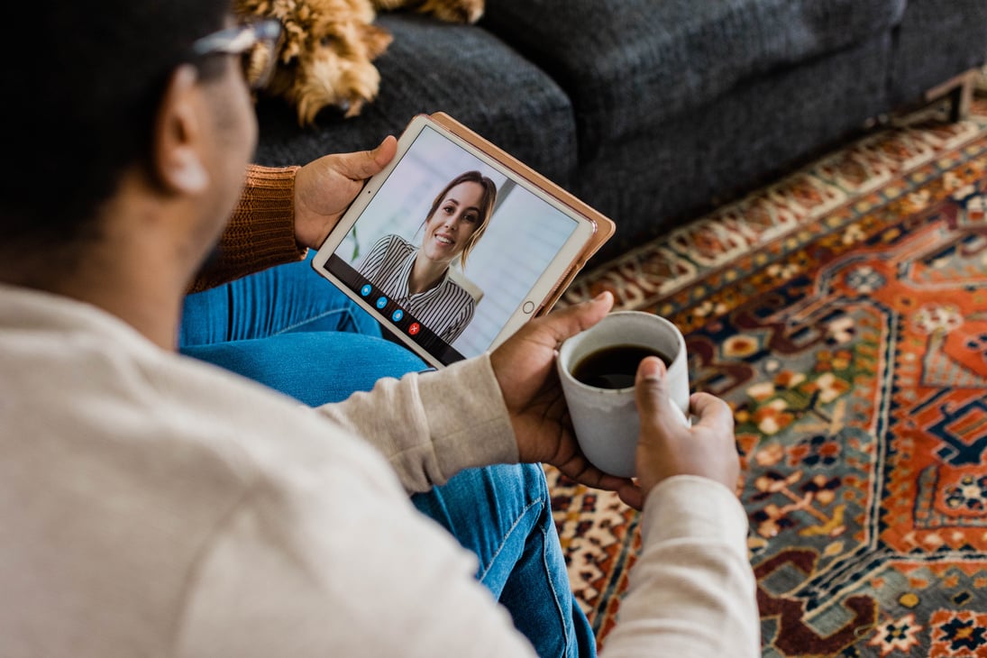 Couple Video Calling a Friend on Digital Tablet